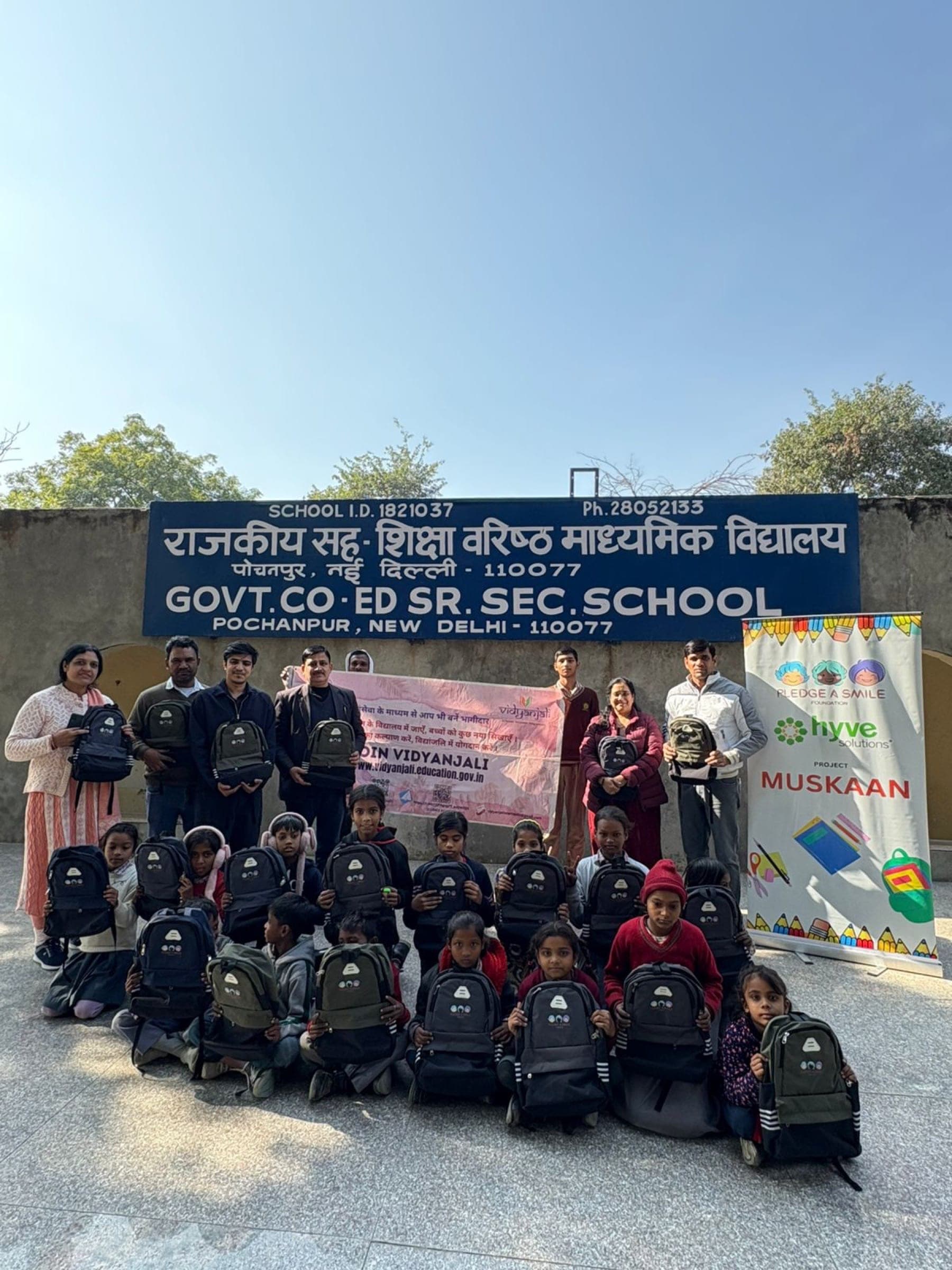 Backpack distribution with Vidyanjali NGO partner banner